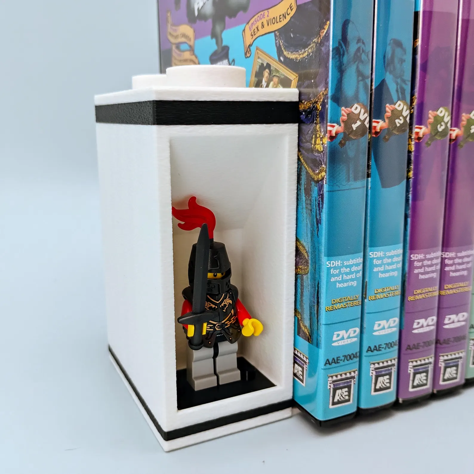 Close-up of knight minifigure displayed inside a LEGO®-style bookend. Crisp white and black contrast highlights collectible figures.