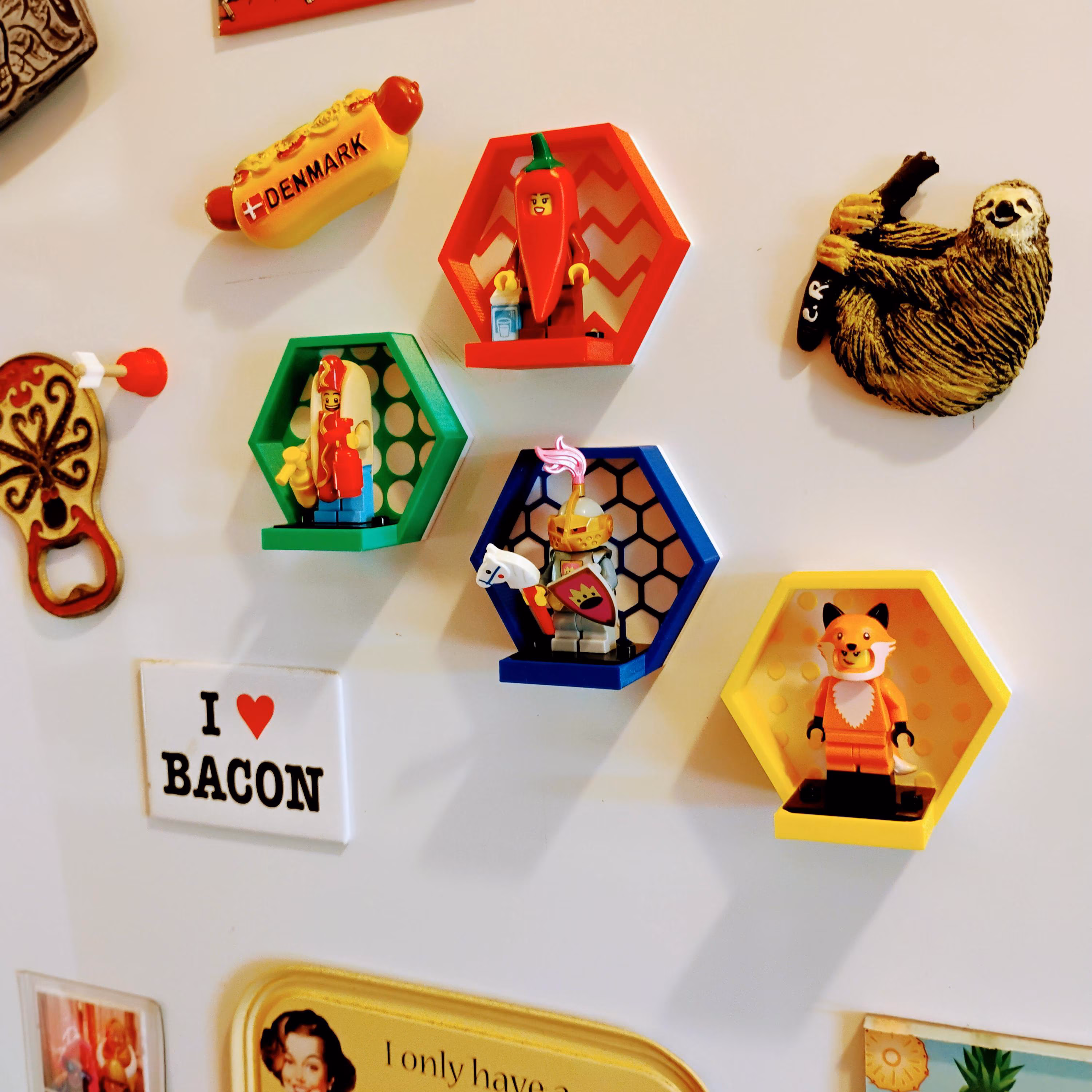 Colorful LEGO® magnetic displays arranged on fridge showing red, yellow, green, blue combinations. Display your LEGO® minifigures in style with strong magnets.